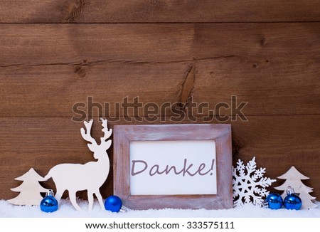 Blue Christmas Decoration On Snow. Balls, Snowflake, Reindeer And Tree. Christmas Card With Picture Frame With German Text Danke Means Thank You. Rustic, Vintage Brown Wooden Background.