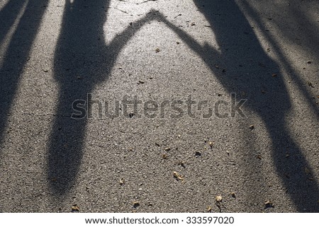 Shadow of women hold their hands together