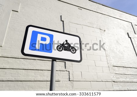 Road sign for parking motorbikes only, against a white wall  in the background England UK.