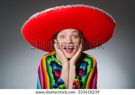 Girl in mexican vivid poncho against gray