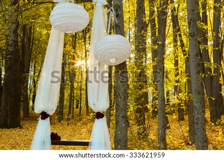 Wedding decorations in autumn forest. Beautiful wedding ceremony in autumn forest. Wedding Design elements.