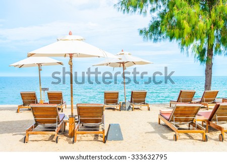 Umbrella and beach chair with beautiful tropical beach - summer vacation background