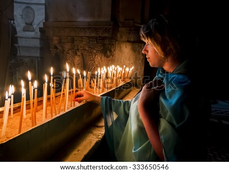 The pilgrims lit candles at the Church of the Holy Sepulchre in Jerusalem, Israel Royalty-Free Stock Photo #333650546