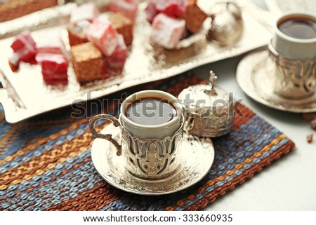 Antique tea-set with Turkish delight on table close-up