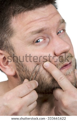 Man with beard and mustache depilating tweezers on face hair close-up isolated on white background