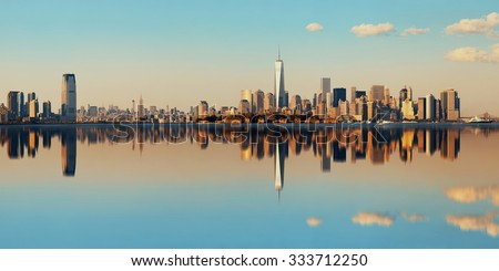 Manhattan downtown skyline with urban skyscrapers over river with reflections.