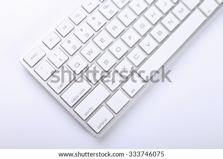 Closeup picture of computer keyboard with white background.