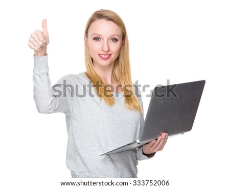 Caucasian woman hold with notebook computer and thumb up 