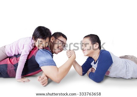 Portrait of young father playing with his children and arm wrestling with his son, isolated on white