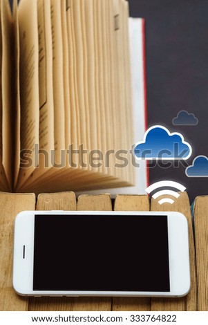 Smart phone and tablet with old books representing e-book and cloud data concept