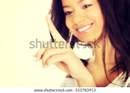 Young african woman touching abstract screen.