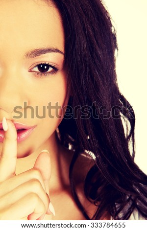 African woman making a hush gesture.