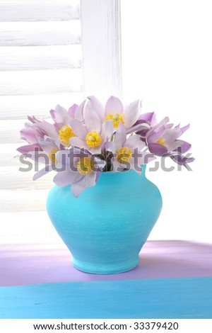 Blue vase with violet flowers