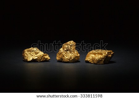 Closeup of big gold nuggets on black background