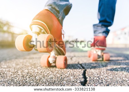 Skater close up in action. Roller skates shoes with sun beam in the background.