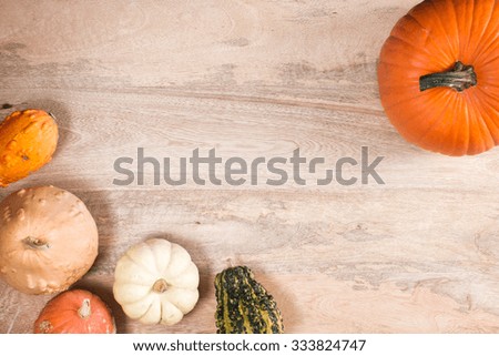 Pumpkins on the wooden table. Add your own text.