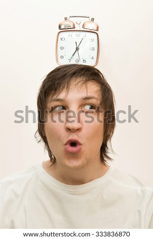 mechanical alarm clock stand on head  funny young white man