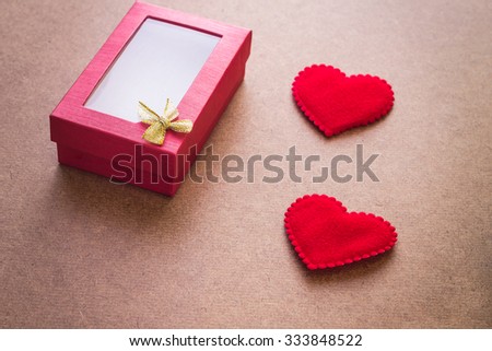Valentine gift box with two hearts on wooden background