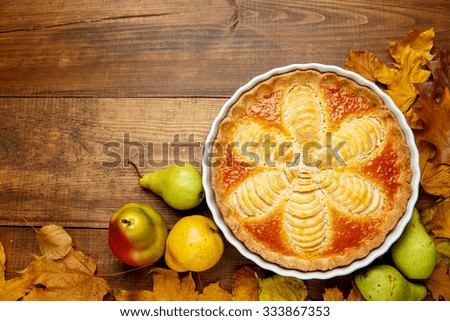 Beautiful fresh organic pear tart on wooden background