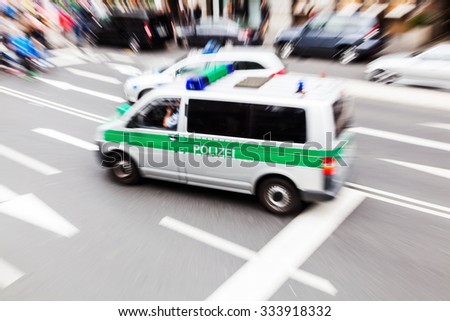 picture with creative zoom effect of a German police van on a city road