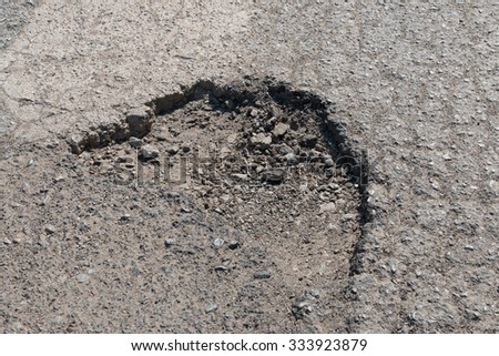 Damaged road in countryside  Royalty-Free Stock Photo #333923879
