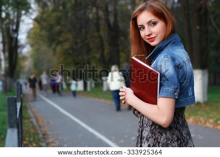 red-haired girl dress folder with documents