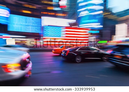 picture with camera made motion blur effect of traffic at night at Times Square, Manhattan, NYC