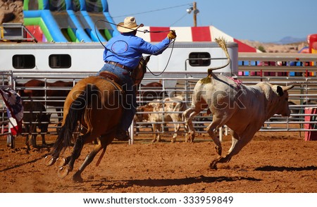 A cowboy chasing a bull with a rope on a rodeo event, Utah, USA Royalty-Free Stock Photo #333959849