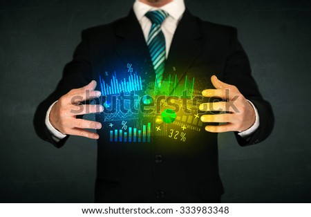 Businessman holding a shining diagram cloud in front of his body 