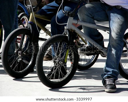 Cyclists waiting to do their stunts at a skate park