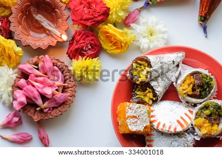 diya lamps lit during diwali celebration with flowers and sweets in background Royalty-Free Stock Photo #334001018