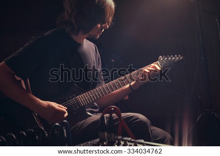 young guitarist play on the electric guitar