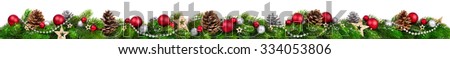 Extra wide Christmas border with fir branches, red and silver baubles, pine cones and other ornaments, isolated on white Royalty-Free Stock Photo #334053806