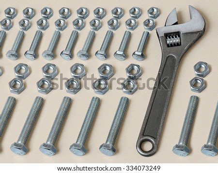 Wrench located among many nuts and bolts