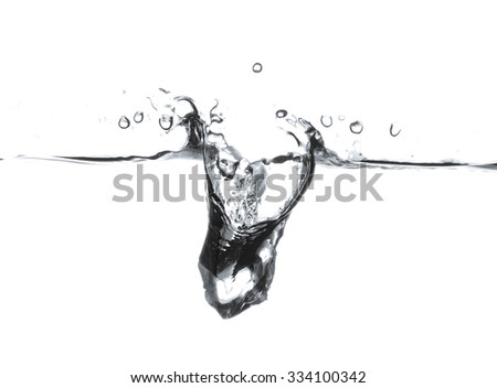 Ice cube is dropped into clear water isolated on white background