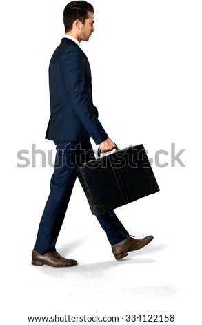 Serious Caucasian man with short dark brown hair in business formal outfit holding briefcase - Isolated