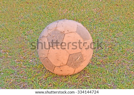 Old soccer ball on soccer field