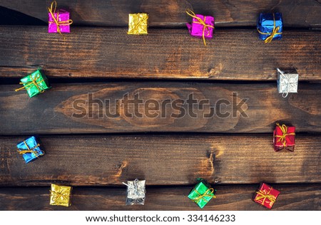 Boxes with gifts on a dark wooden boards. Happy new year. Space for text. Old background. New Year background.