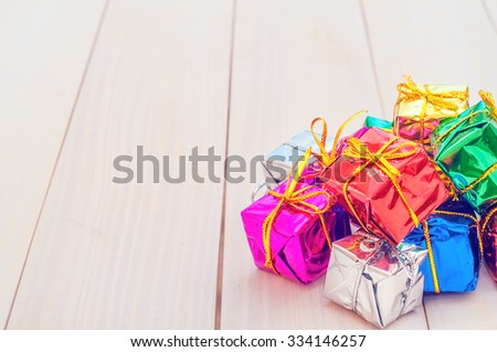 Christmas gifts. Boxes with gifts on a light wooden boards. White notepad. Happy new year. Space for text. Old background. New Year background. Christmas. Xmas. Noel. Valentine Day. Love.