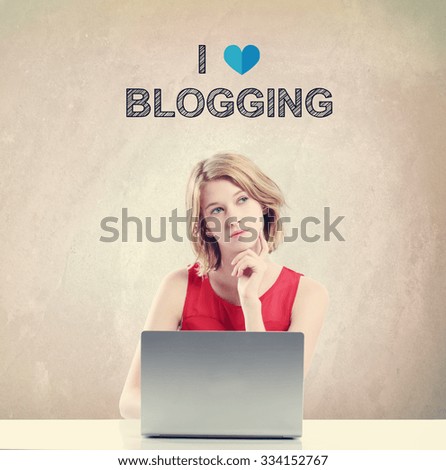  I Love Blogging concept with young woman working on a laptop 