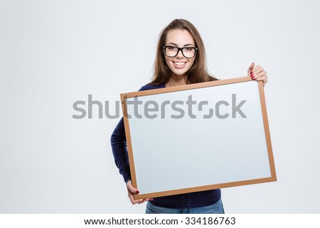 Portrait of a smiling young woman holding blank board isolated on a white background