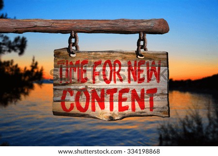 Time for new content motivational phrase sign on old wood with blurred background