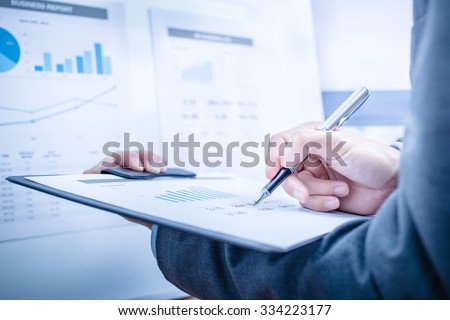Businessman analyzing investment charts. Accounting Royalty-Free Stock Photo #334223177