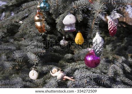  Old toys on the Christmas tree .Christmas toys on blue spruce