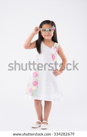 Full-length portrait of cute little girl in summer dress