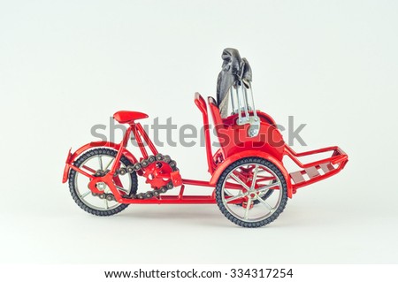 Red trishaw on white background.