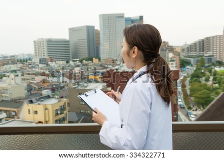 asian woman doctor having binder outdoor 