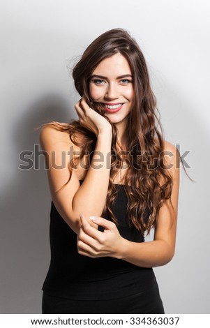 young beautiful stylish girl in a black business dress and sunglasses standing on a white background with a snow-white smile, smiling, picture with depth of field,  instagram filter