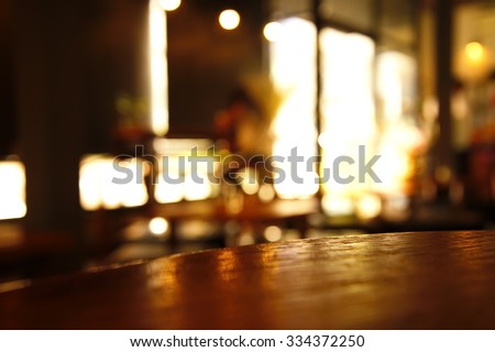 blur light on window with empty wood top table in cafe for display product   Royalty-Free Stock Photo #334372250