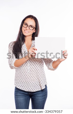 Portrait of cheerful beautiful woman showing blank signboard with copyspace area for text or slogan